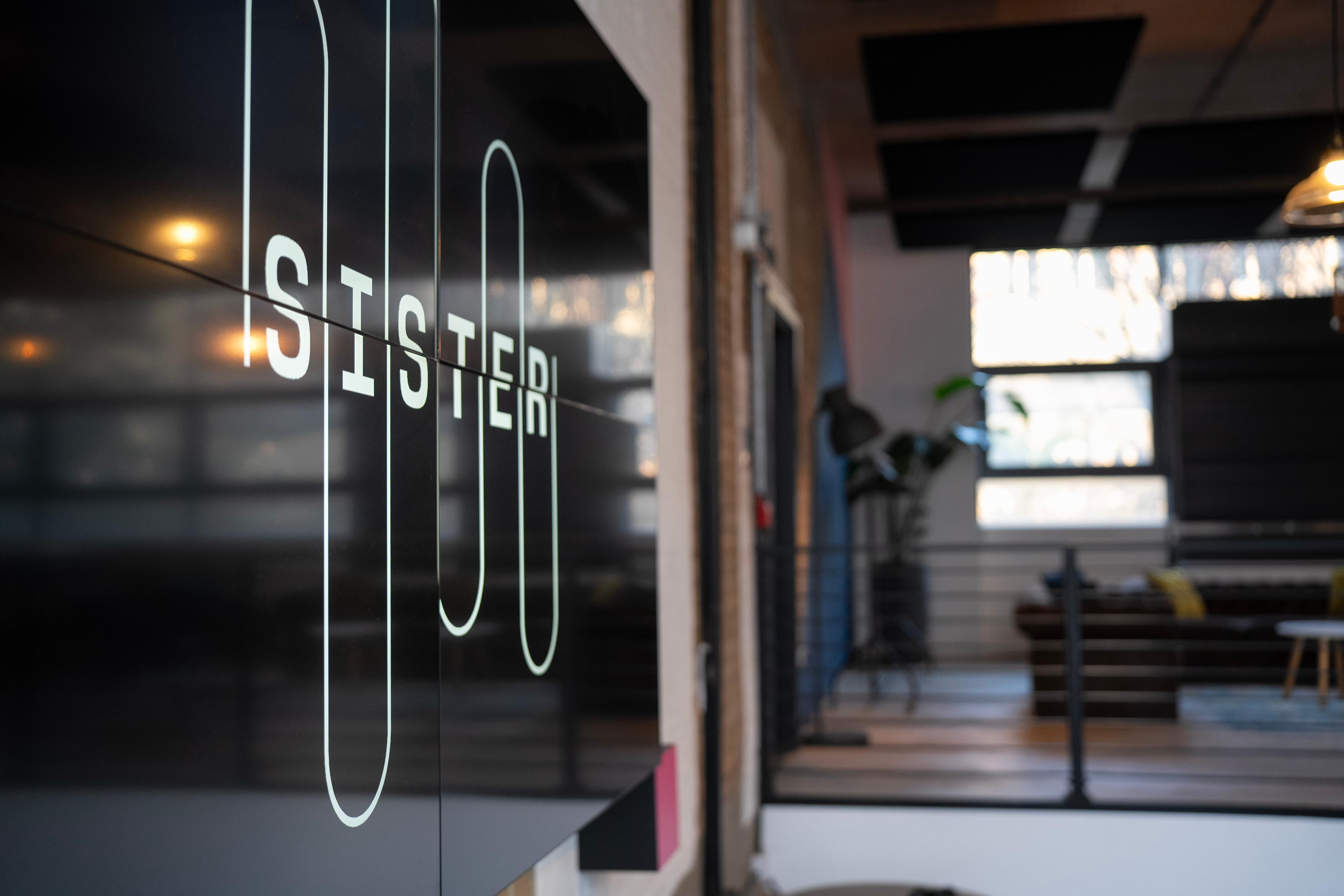 Sister logo on screen at the London launch event