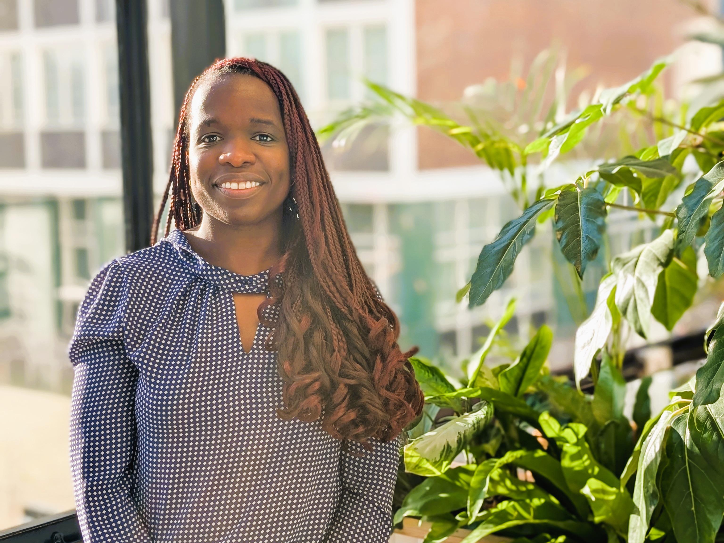 Woman with blue louse smiling 