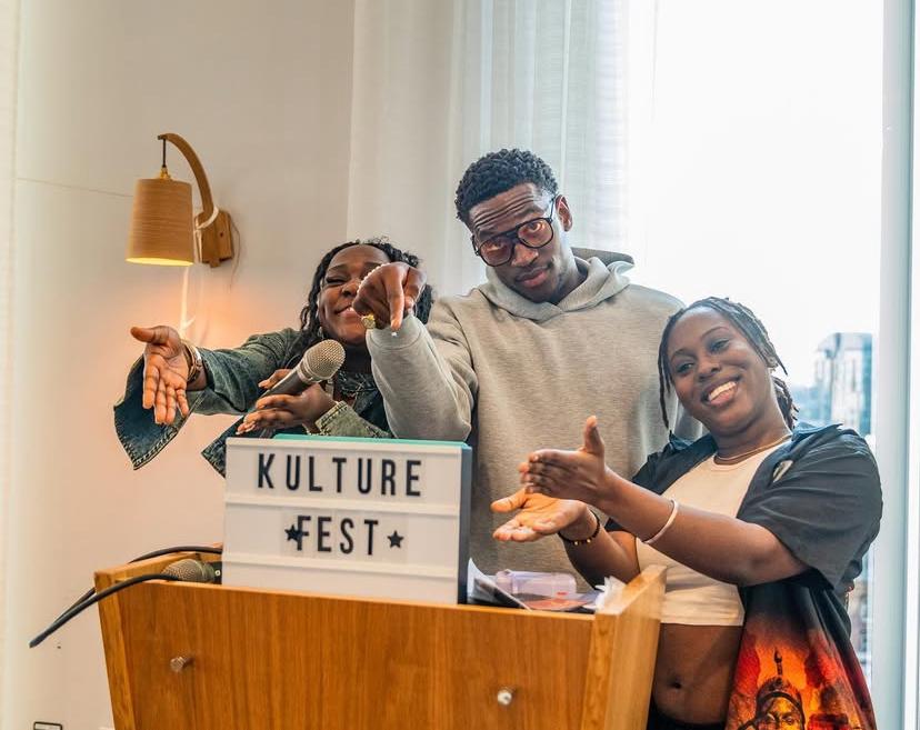 young people pointing at Kulture Fest sign 