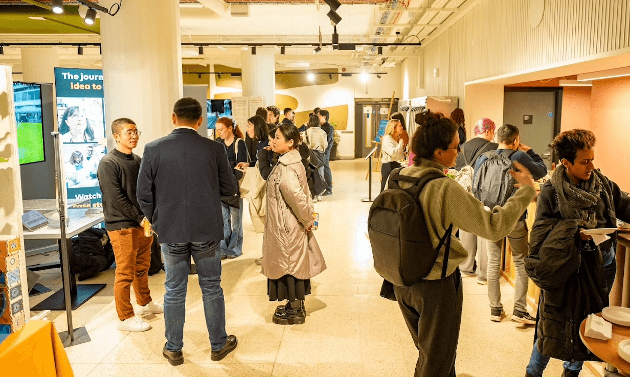 Group of people walking around the innovation exhibits 