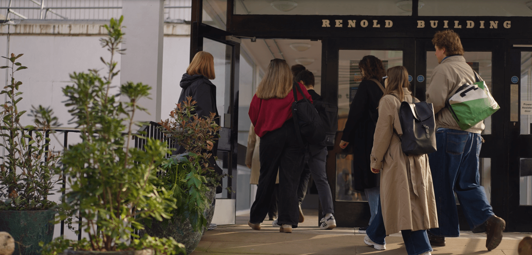 Group of people walking into the Renold building