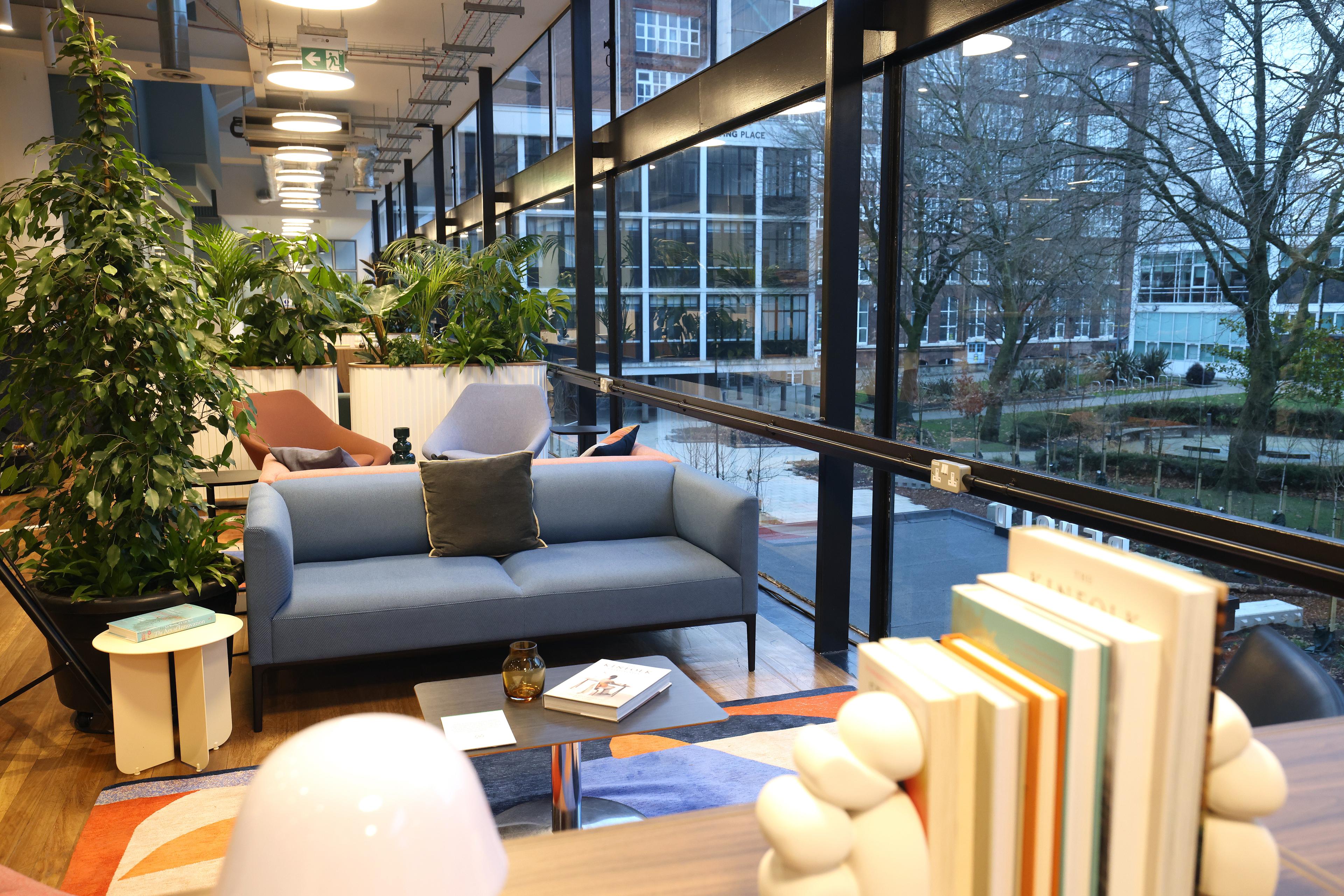 Sofa area with tables and a bookshelf