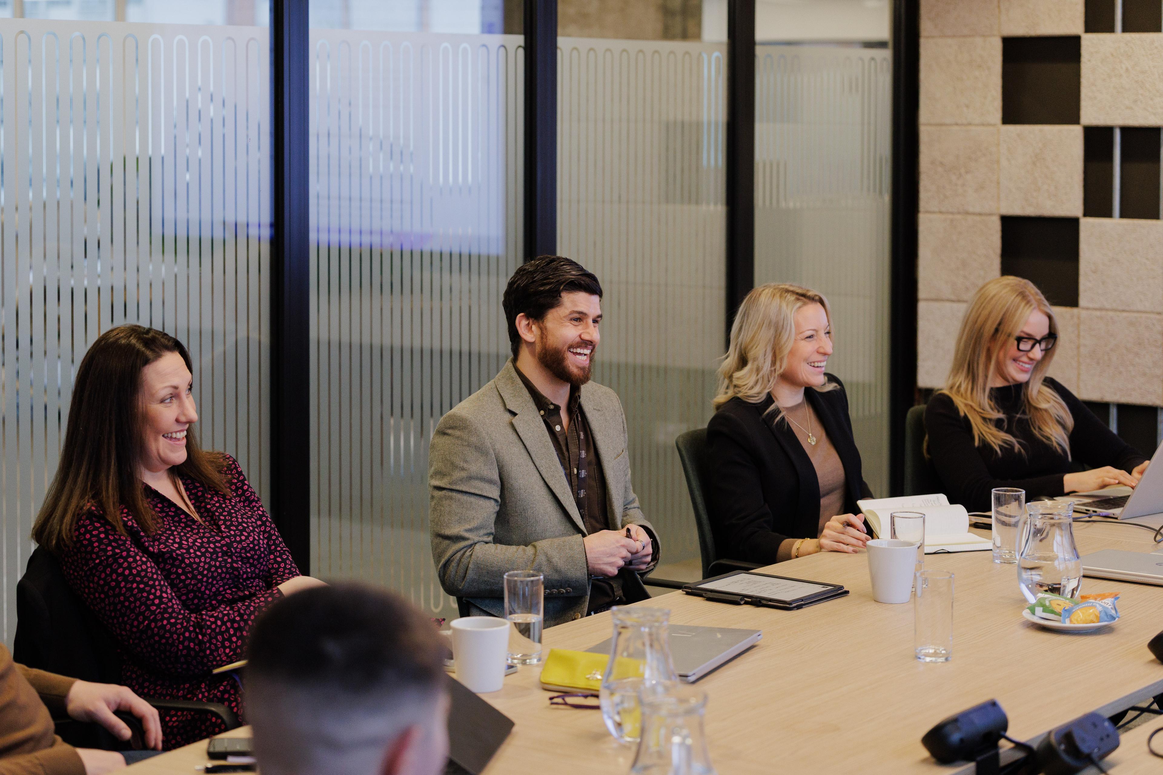People smiling around a table 