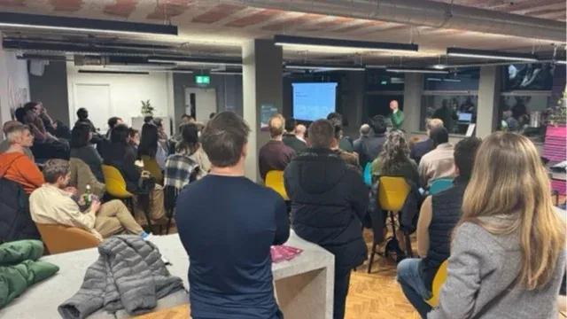 People Facing a screen watching a presentation.