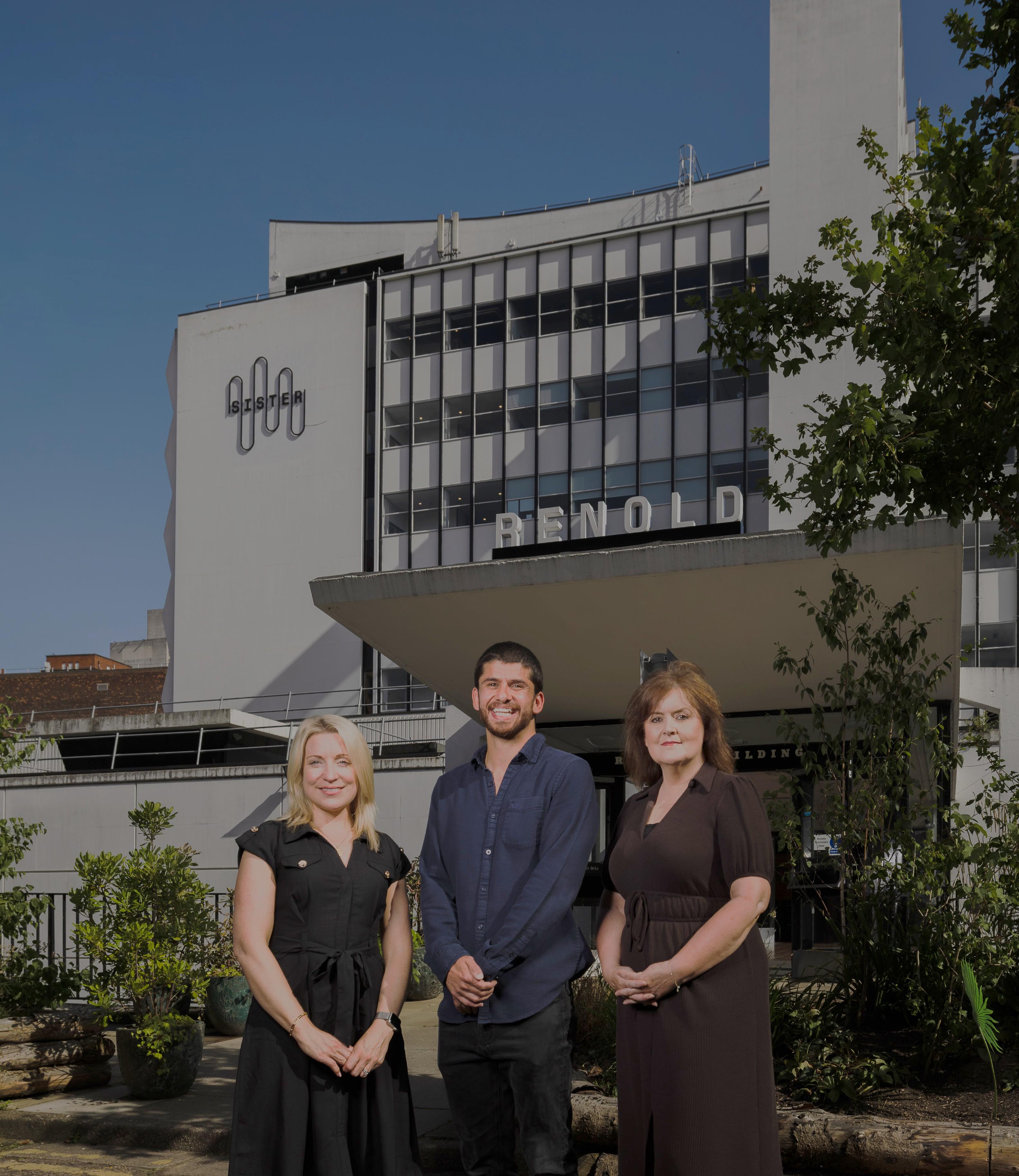 Liz, Karim and Niamh stood outside the front of the Renold Building, Sister